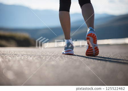 Fitness woman runner running at sunset mountain top road 125522462