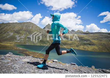 Fitness woman runner running at beautiful mountain top Fitness woman runner running at beautiful mountain top 125522471