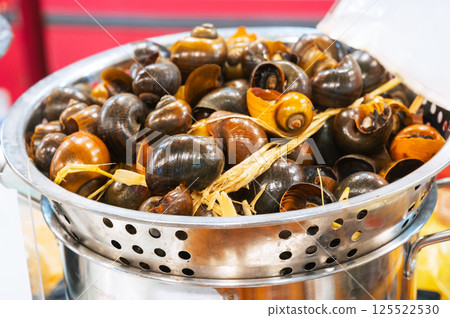 Boiled snails at Asian night market in Asia. Traditional Vietnamese street food in Vietnam Boiled snails at Asian night market in Asia. Traditional Vietnamese street food in Vietnam 125522530
