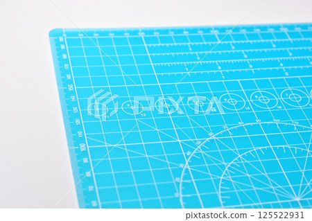 blue cutting mat board on white background with line and scale measure guide pattern for art design 125522931
