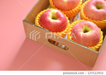 beautiful pink apple in the box on pink background beautiful pink apple in the box on pink background 125522932