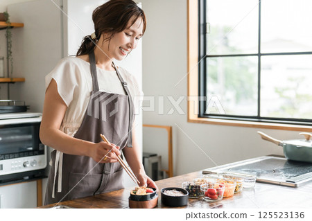 Young Asian woman (mother, wife, housewife) packing lunch in the kitchen 125523136