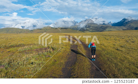 Aerial view of woman trail runner in high altitude mountains 125523187