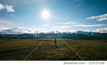 Aerial view of woman trail runner in high altitude mountains 125523188