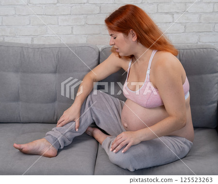 Caucasian pregnant woman suffering from leg cramps. Third trimester.  125523263