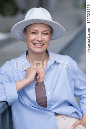 Portrait of stylish mature woman in white hat. Portrait of stylish mature woman in white hat. 125523336