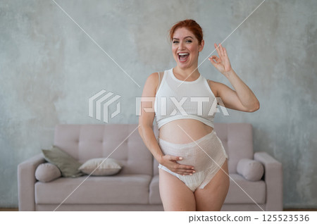 Happy Pregnant Woman Recommends Adult Diapers. Happy Pregnant Woman Recommends Adult Diapers. 125523536