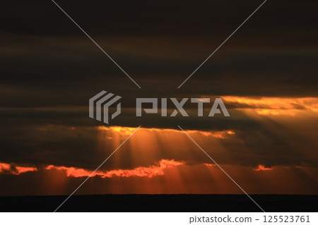 Angel's ladder pouring into the sea 125523761