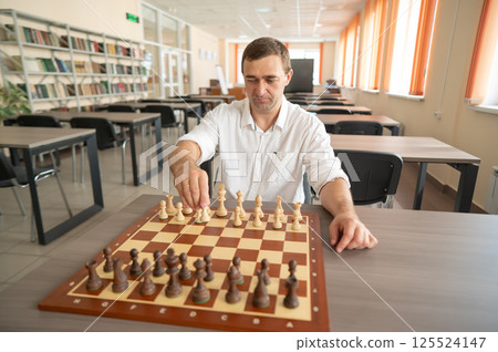 Portrait Caucasian man playing chess.  125524147