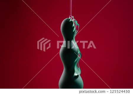 Lube pouring onto green anal beads on pink background.  125524430