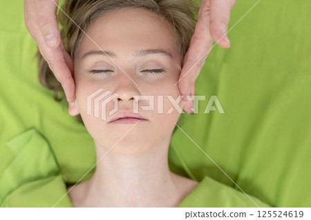 Top view of woman getting facial massage. Top view of woman getting facial massage. 125524619
