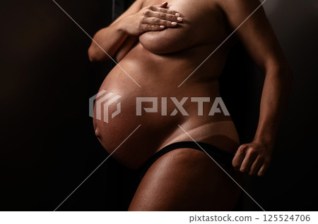Pregnant woman pulls back her panties showing instant tan. Vertical photo. Pregnant woman pulls back her panties showing instant tan. Vertical photo. 125524706