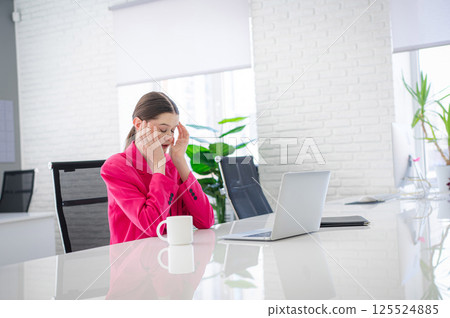 Caucasian woman makes mistake at work and holds her head. Caucasian woman makes mistake at work and holds her head. 125524885