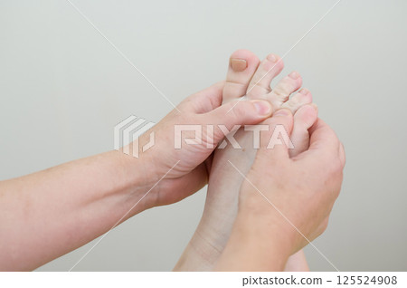 Close up of a woman's foot being massaged.  125524908