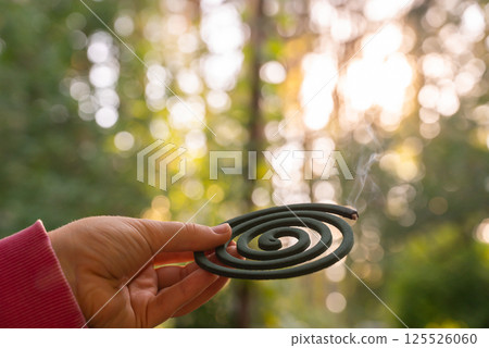 Unrecognizable woman using Repellent Stick disease prevention. Protection against mosquito bite during summertime. Safety Anti Mosquito skin treatment 125526060