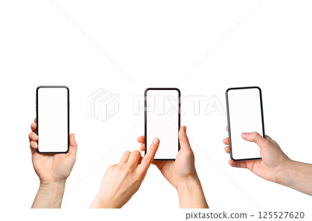 Hands showcase three smartphones with blank displays for use, isolated on white 125527620