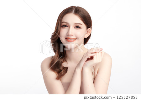 A beautiful young Asian woman with clean, fresh skin against a white background. Skincare, facial treatment, cosmetology, beauty, and spa. An elegant portrait of an Asian woman. 125527855