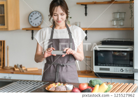 A woman taking a cook with a smartphone A woman taking a cook with a smartphone 125527962