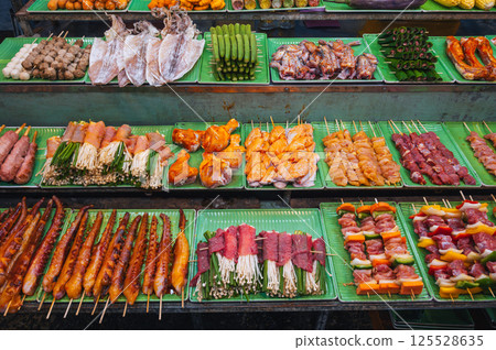 assortment of traditional Vietnamese street food on counter at Asian Night Market in Vietnam in Asia 125528635