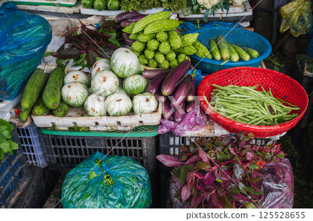 assortment of various vegetables at street grocery and vegetable market in Asia in Vietnam 125528655