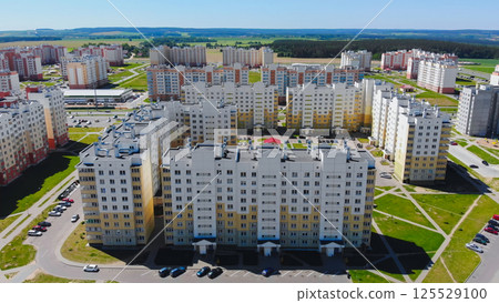 Modern residential district with colorful apartment buildings under blue sky Modern residential district with colorful apartment buildings under blue sky 125529100