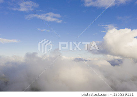 Aerial view white clouds in blue sky. View from drone. Aerial top view cloudscape texture. Texture of clouds. View from above. Panorama clouds background 125529131