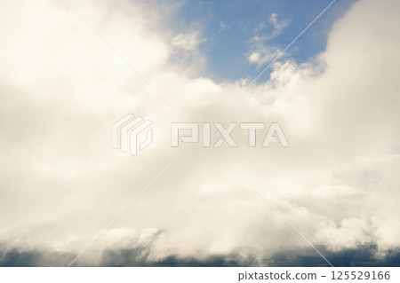 Aerial view clouds over the forest and lake. View from drone. Aerial top view cloudscape. Texture of clouds. View green forest from above covered with white clouds Aerial view clouds over the forest and lake. View from drone. Aerial top view cloudscape. Texture of clouds. View green forest from above covered with white clouds 125529166