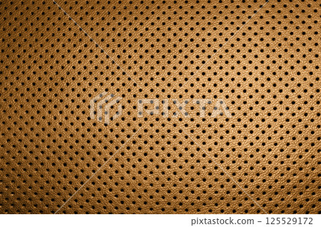 Modern luxury car brown leather interior. Part of perforated orange leather car seat details. Perforated leather texture background. Texture, artificial leather with stitching. Perforated leather Modern luxury car brown leather interior. Part of perforated orange leather car seat details. Perforated leather texture background. Texture, artificial leather with stitching. Perforated leather 125529172