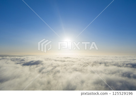 Aerial view white clouds in blue sky. View from drone. Aerial top view cloudscape. Texture of clouds. View from above. Panorama clouds Aerial view white clouds in blue sky. View from drone. Aerial top view cloudscape. Texture of clouds. View from above. Panorama clouds 125529196