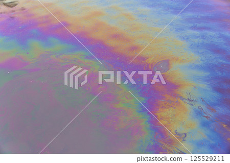 Oil petrol water pollution. Ecological disaster. Slick industry oil fuel spilling water pollution. Water with patches of gasoline and oil. Ecological catastrophy.  Concept of environmental problems 125529211