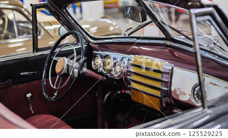 Interior view of vintage convertible car showing steering wheel and dashboard 125529225
