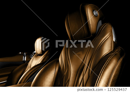 Modern Luxury car brown leather interior. Comfortable orange leather seats with stitching. Perforated leather interior Modern Luxury car brown leather interior. Comfortable orange leather seats with stitching. Perforated leather interior 125529437