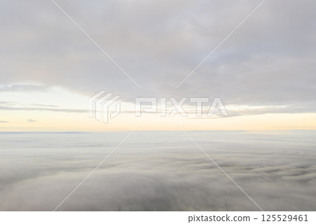 Aerial view white clouds. View from drone. Aerial top view cloudscape texture. Texture of clouds. View from above. Panorama clouds background Aerial view white clouds. View from drone. Aerial top view cloudscape texture. Texture of clouds. View from above. Panorama clouds background 125529461