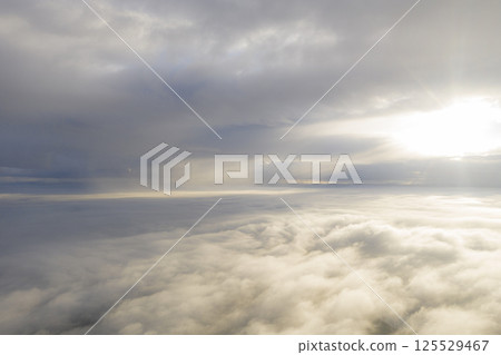 Aerial view white clouds in blue sky. View from drone. Aerial view cloudscape texture background. Texture of clouds. View from above. Panorama clouds background 125529467