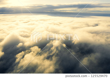 Aerial view white clouds in blue sky. View from drone. Aerial view cloudscape texture background. Texture of clouds. View from above. Panorama clouds background 125529470