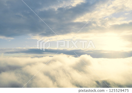 Aerial view white clouds in blue sky. View from drone. Aerial view cloudscape texture background. Texture of clouds. View from above. Panorama clouds background 125529475
