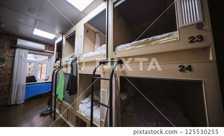 Capsule hotel beds providing comfortable and affordable accommodation Capsule hotel beds providing comfortable and affordable accommodation 125530255