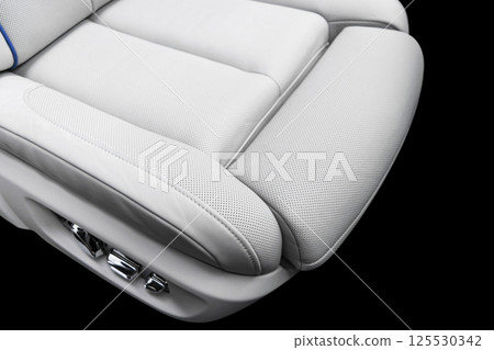 White leather interior of the luxury modern car. Perforated white leather comfortable seats with stitching isolated on black background. Modern car interior details. Car detailing. Car inside White leather interior of the luxury modern car. Perforated white leather comfortable seats with stitching isolated on black background. Modern car interior details. Car detailing. Car inside 125530342