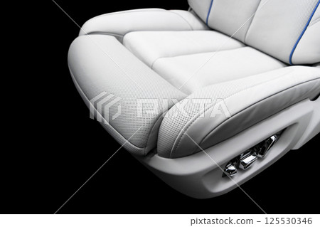 White leather interior of the luxury modern car. Perforated white leather comfortable seats with stitching isolated on black background. Modern car interior details. Car detailing. Car inside White leather interior of the luxury modern car. Perforated white leather comfortable seats with stitching isolated on black background. Modern car interior details. Car detailing. Car inside 125530346