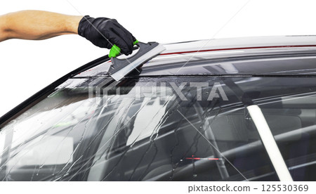A man cleaning car with plastic sponge. Car detailing or valeting concept. Selective focus. Car detailing. Cleaning with sponge and cloth. Worker cleaning. Car wash concept solution to clean 125530369