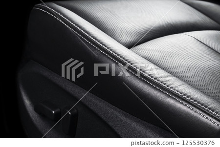 Modern Luxury car inside. Interior of prestige modern car. Comfortable leather seats. Perforated leather with stitching isolated on black background. Modern car interior. Car detailing. Car inside Modern Luxury car inside. Interior of prestige modern car. Comfortable leather seats. Perforated leather with stitching isolated on black background. Modern car interior. Car detailing. Car inside 125530376