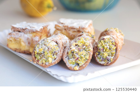 Cannoli traditional dessert of Italy. Food and sweets. Tubes of dough with filling. National cuisine. Cannoli traditional dessert of Italy. Food and sweets. Tubes of dough with filling. National cuisine. 125530440