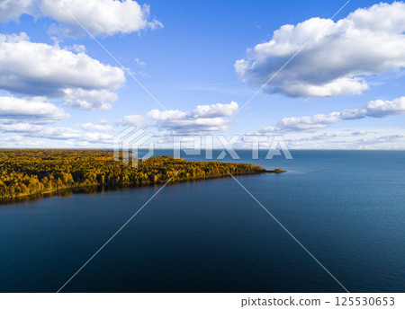 Aerial view of seashore with beach, lagoons. Coastline with sand and water. Landscape. Aerial photography. Birdseye. Sea, beach, sky, clouds. Autumn yellow trees and forest Aerial view of seashore with beach, lagoons. Coastline with sand and water. Landscape. Aerial photography. Birdseye. Sea, beach, sky, clouds. Autumn yellow trees and forest 125530653