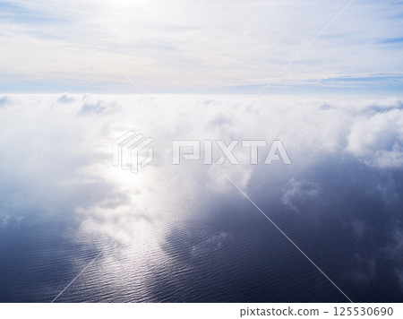 Aerial view White clouds in blue sky. Top view. View from drone. Aerial bird's eye view. Aerial top view cloudscape. Texture of clouds. View from above. Sunrise over the sea Aerial view White clouds in blue sky. Top view. View from drone. Aerial bird's eye view. Aerial top view cloudscape. Texture of clouds. View from above. Sunrise over the sea 125530690