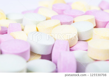 Colorful medicine pills and drugs in close up. Different kinds of multicolored tablets. Assorted pills in medicine. Pharmaceutical medicine pills and tablets. Health care. Pills background 125530708