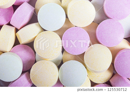 Colorful medicine pills and drugs in close up. Different kinds of multicolored tablets. Assorted pills in medicine. Pharmaceutical medicine pills and tablets. Health care. Pills background 125530712