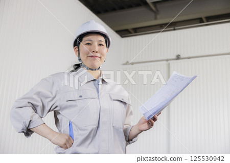 Middle-aged woman wearing work clothes 125530942