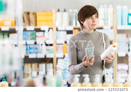 Middle-aged woman choosing skincare products at pharmacy Middle-aged woman choosing skincare products at pharmacy 125531073