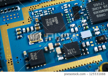 Macro shot of Circuit board with resistors microchips and electronic components. Computer hardware technology. Integrated communication processor. Information engineering. Semiconductor. PCB. Closeup Macro shot of Circuit board with resistors microchips and electronic components. Computer hardware technology. Integrated communication processor. Information engineering. Semiconductor. PCB. Closeup 125531088