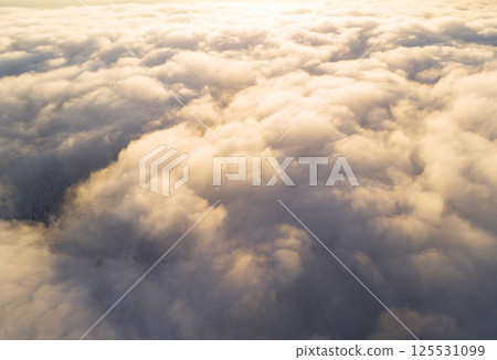 Aerial view White clouds in blue sky. Top view. View from drone. Aerial bird's eye view. Aerial top view cloudscape. Texture of clouds. View from above. Sunrise or sunset over clouds Aerial view White clouds in blue sky. Top view. View from drone. Aerial bird's eye view. Aerial top view cloudscape. Texture of clouds. View from above. Sunrise or sunset over clouds 125531099